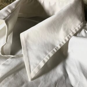 BAJJI organic cotton dress in sand tone on clean light background with soft shadow