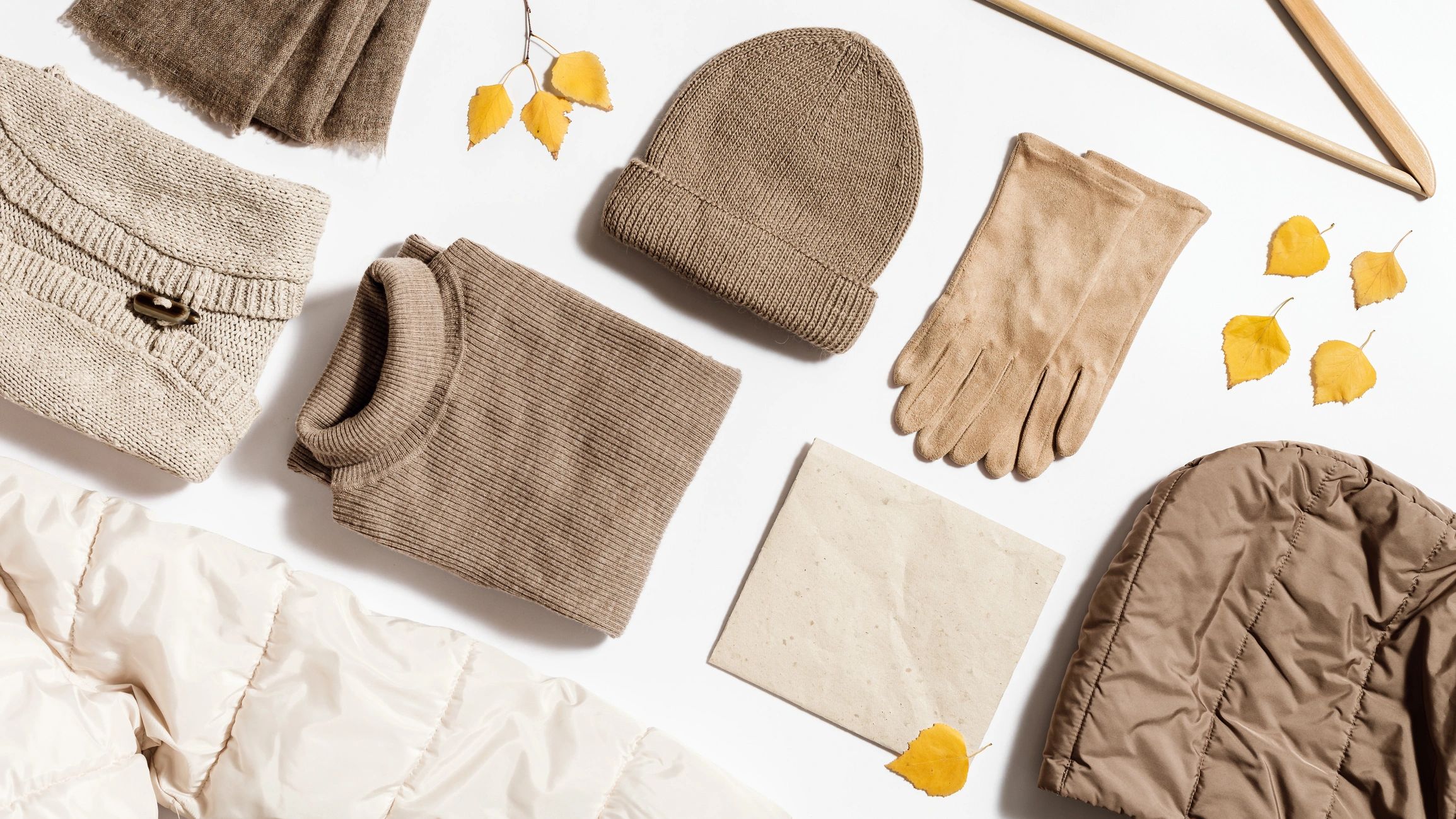 Neutral-toned clothing flat lay, representing a versatile wardrobe palette