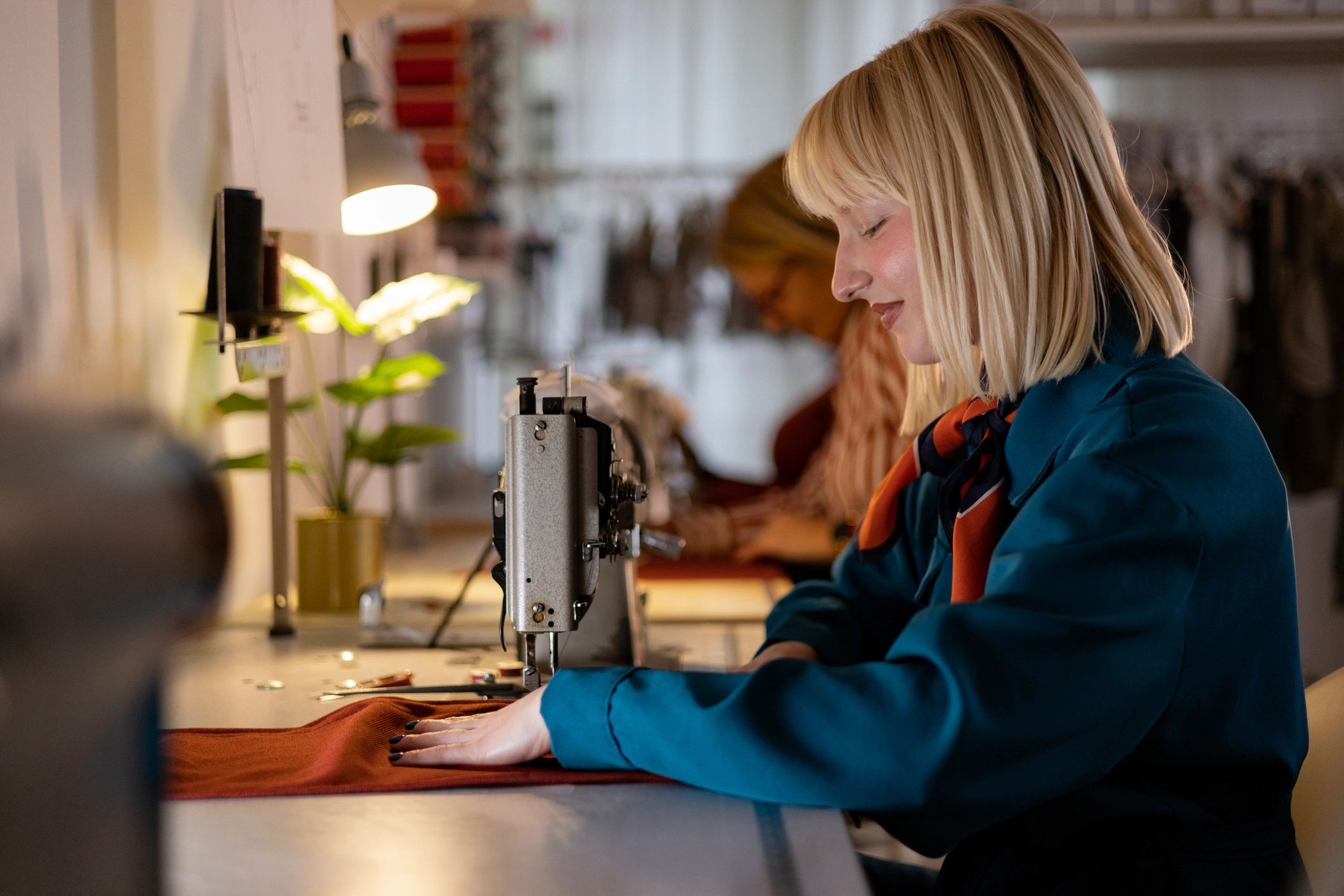 Tailor working at a sewing machine in a clothing studio