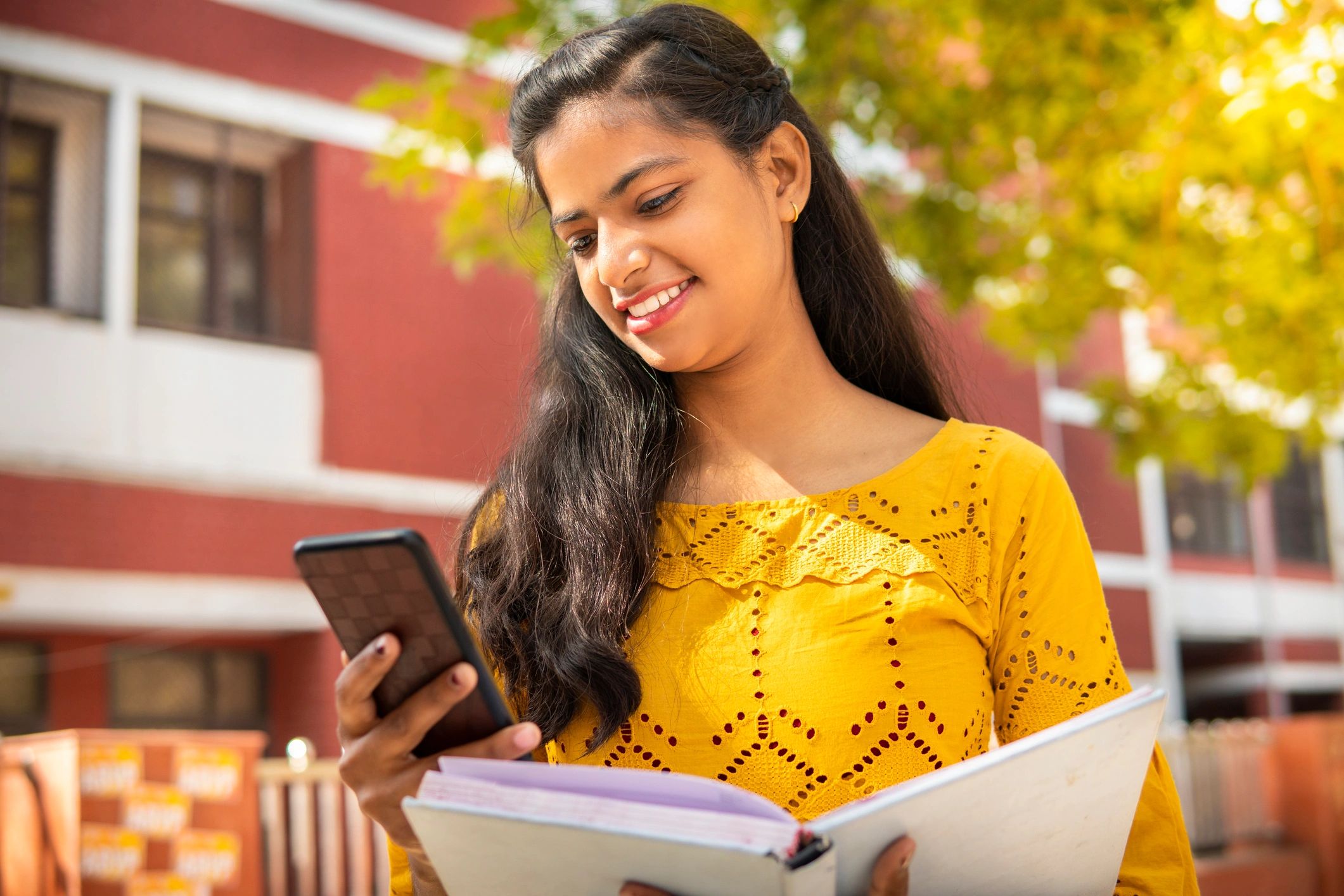 Smiling woman holding a book, representing a happy customer
