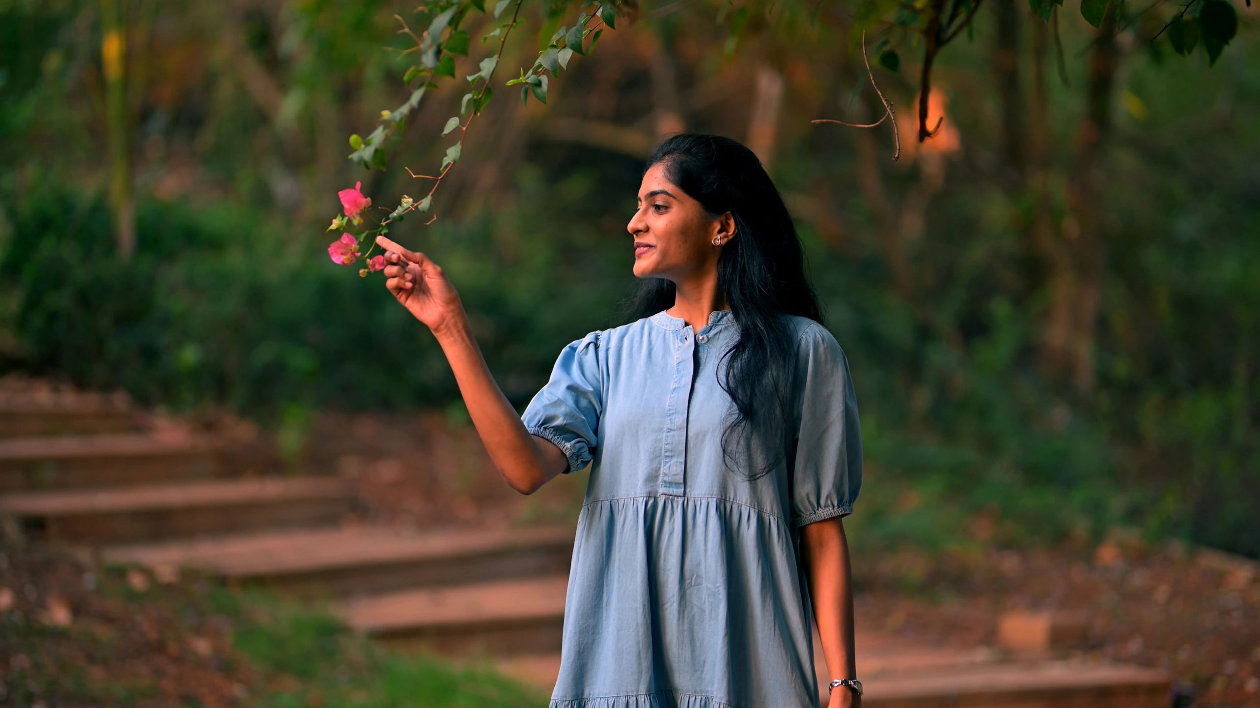 Woman outdoors in soft morning light, representing breathable everyday style